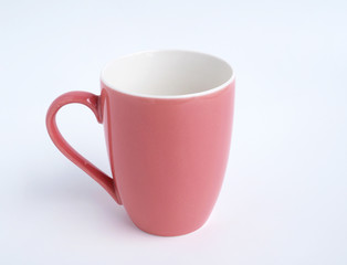 Empty pink mug for coffee or tea isolated on white background.