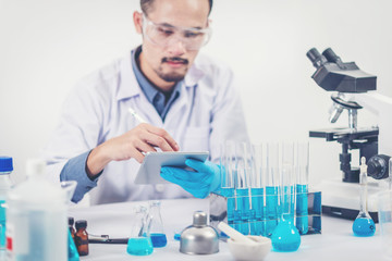 scientist with equipment and science experiments ,laboratory glassware containing chemical liquid for design or decorate science or other your content and selective focus