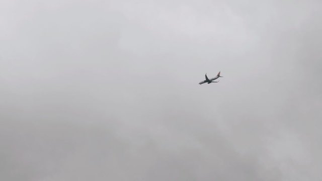 The plane flies in the cloudy sky. Low cloud. bad weather. The plane took off.