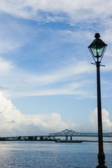 Streetlamp and Bridge Silhouetted Against Mississippi River with Cloudscape