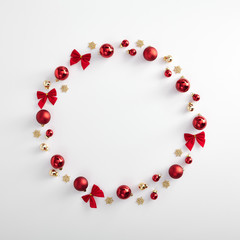 Red christmas ball, bow and gold snowflake layout
