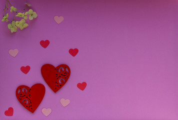 Red and pink hearts on a purple background. Valentin's Day, top view. 