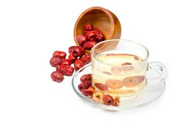 Healthy drink brewed from Chinese jujube in a clear glass container placed on white background with...