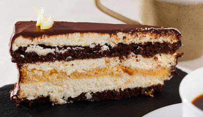 Piece of chocolate lemon cake on black board