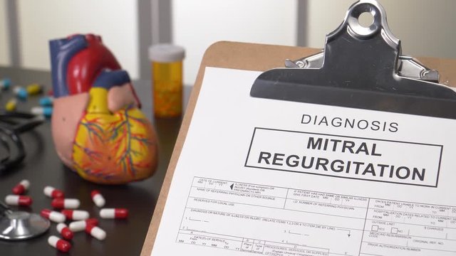 Mitral regurgitation diagnosis document panning shot. Heart disease medical concept