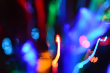 Fototapeta na wymiar Defocused abstract background image. Drawing with light at low shutter speed. X-mas New year party creative background.