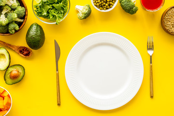 Diet program concept. Empty plate, measure tape and vegetables on yellow background top view mockup