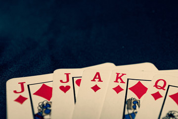 euchre diamond hand on black background