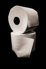 Stacked toilet Paper rolls on black background