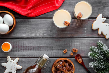 Make festive drink eggnog - ingredients on dark wooden background top view frame copy space