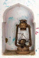 Beautiful photo of an obsolete and antique kerosene oil lantern kept in a wall shelf, once widely...