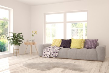 Stylish room in white color with sofa and summer landscape in window. Scandinavian interior design. 3D illustration