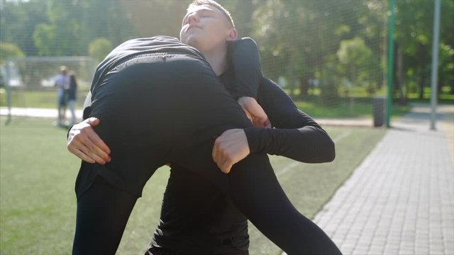 Two fighters practice mma skills in training