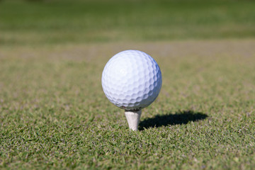 golf ball on tee pegs ready to play in the golf course