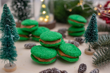 Home made green christmas sugar cookies on a festive christmas background