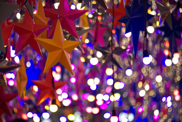 Orange and red stars with colorful bubble blur background