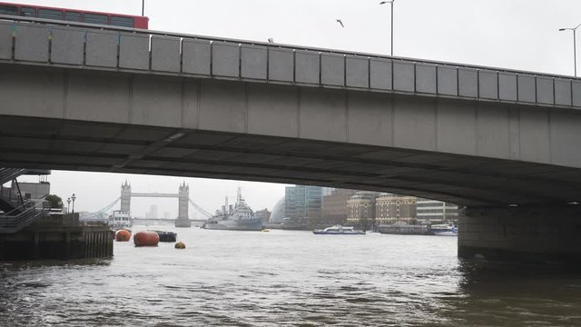 A View Of The Tower Bridge Underneath A Bridge In A Fog.