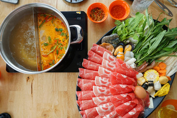 dish of thinly sliced meat and vegetables boiled in water and served with dipping sauces.