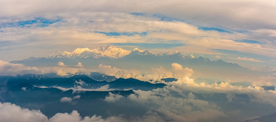 Snowy Himalayan mountain ranges through the clouds