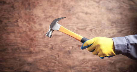 Worker holding hammer. Construction tool