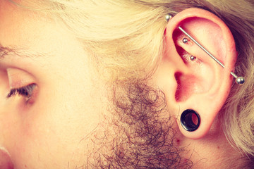 Pierced man ear, black plug tunnel, industrial and rook