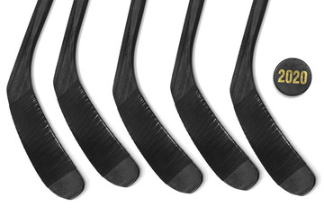 Five hockey sticks and puck on a white background