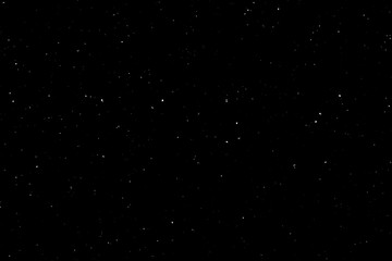 WHITE BOKEH ON A BLACK BACKGROUND. LIGHT SPOTS TEXTURE. FALLING SNOW. STAR SKY.