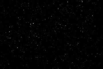 WHITE BOKEH ON A BLACK BACKGROUND. LIGHT SPOTS TEXTURE. FALLING SNOW. STAR SKY.