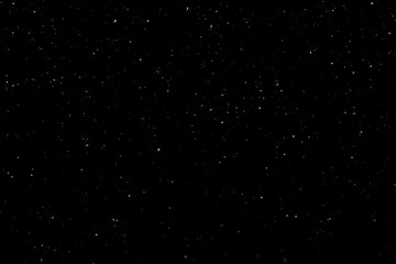 WHITE BOKEH ON A BLACK BACKGROUND. LIGHT SPOTS TEXTURE. FALLING SNOW. STAR SKY.