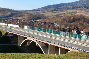 Obraz premium LUBIEN, POLAND - NOVEMBER 24, 2019: Modern highway bridge and villages around it