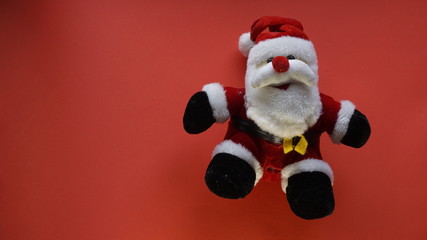 teddy bear as santa claus in a red background