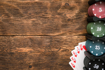 Royal Flush cards and poker chips on green flat lay background.