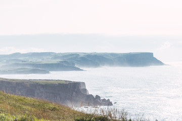 Misty landscape of ocean and cliffs