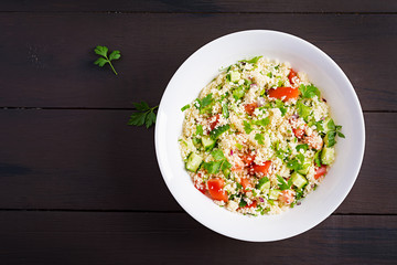 Traditional Lebanese Salad Tabbouleh. Couscous with parsley, tomato, cucumber, lemon and olive oil....