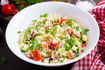 Traditional Lebanese Salad Tabbouleh. Couscous with parsley, tomato, cucumber, lemon and olive oil. Middle Eastern cuisine.