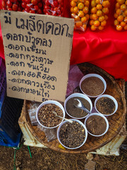 Dried seeds of flowers in the white bowl ,Flowers Name tag sign
