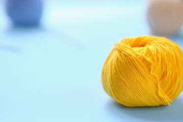 Bright color yarn clews on the blue background. Concept of amigurumi toy making, handicraft, knitting, hobbie.