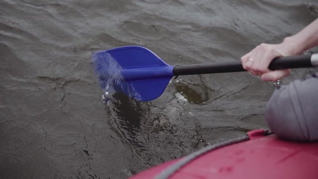 man rows paddle in boat