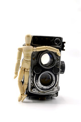 old photo camera and wooden mannequin  isolated on white background