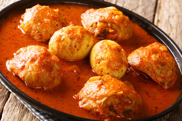 Doro Wat is Ethiopian stew of chicken thighs with eggs in a spicy sauce close-up in a plate....