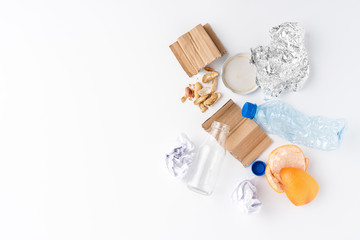 Naklejka na ściany i meble Overhead shot of different kinds of garbage - plastic, glass, paper, metal, plastic and organic. Waste management concept. Flat lay