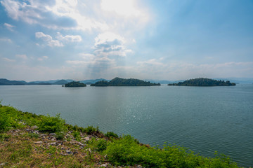 beautiful blue sky green forest mountains lake view at Kaeng Krachan National Park, Thailand.  an idea for backpacker hiking on long weekend or a couple, family holiday activity camping relaxing