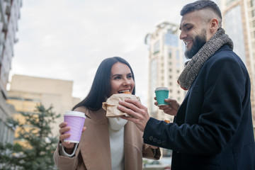 Joyful happy man feeding his beloved wife