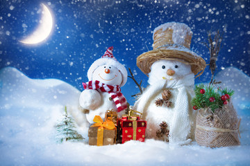 Snowman in a snowdrift with gifts for Christmas and New year