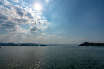 beautiful blue sky green forest mountains lake view at Kaeng Krachan National Park, Thailand.  an idea for backpacker hiking on long weekend or a couple, family holiday activity camping relaxing