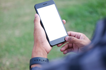 Mockup smartphone of man’s holding black mobile phone with white screen in his office.