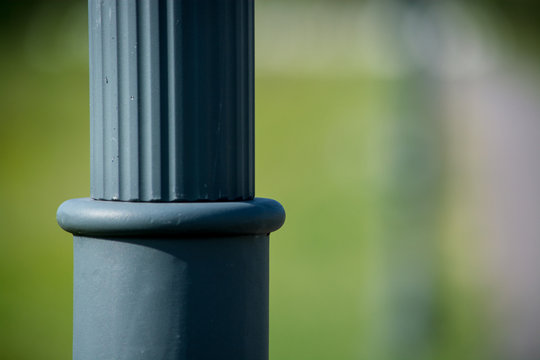 Element metal lamp post. Blurred background.