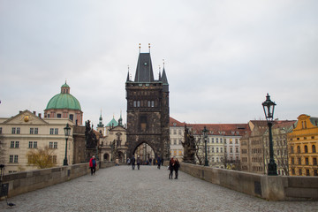 Naklejka premium The oldest bridge in Prague Charles Bridge at dawn on the eve of the Christmas holidays with virtually no tourists.