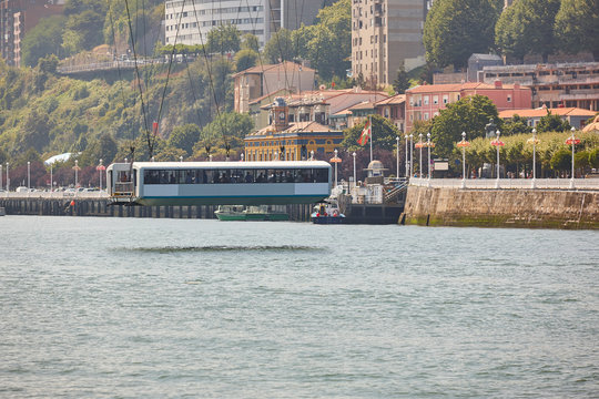 Bizkaia red iron hanging bridge and Nervion river. Euskadi