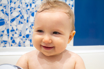 Child plays with a shower in the bathroom